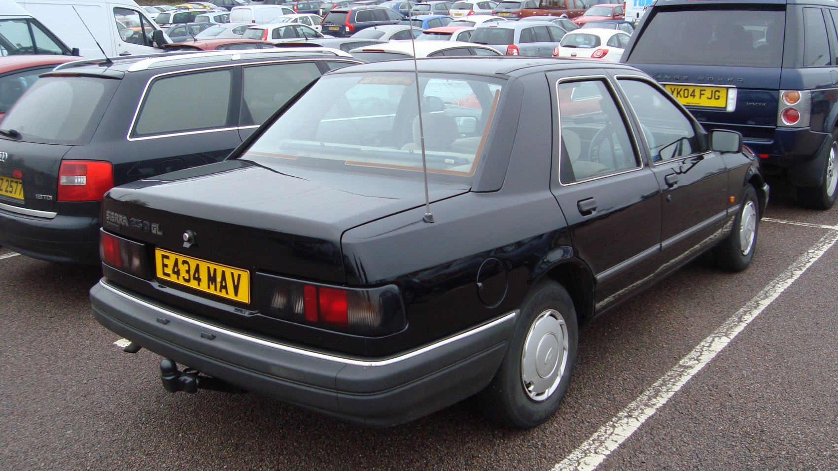 Rear view of a boxy sedan with antenna and integrated tail lights