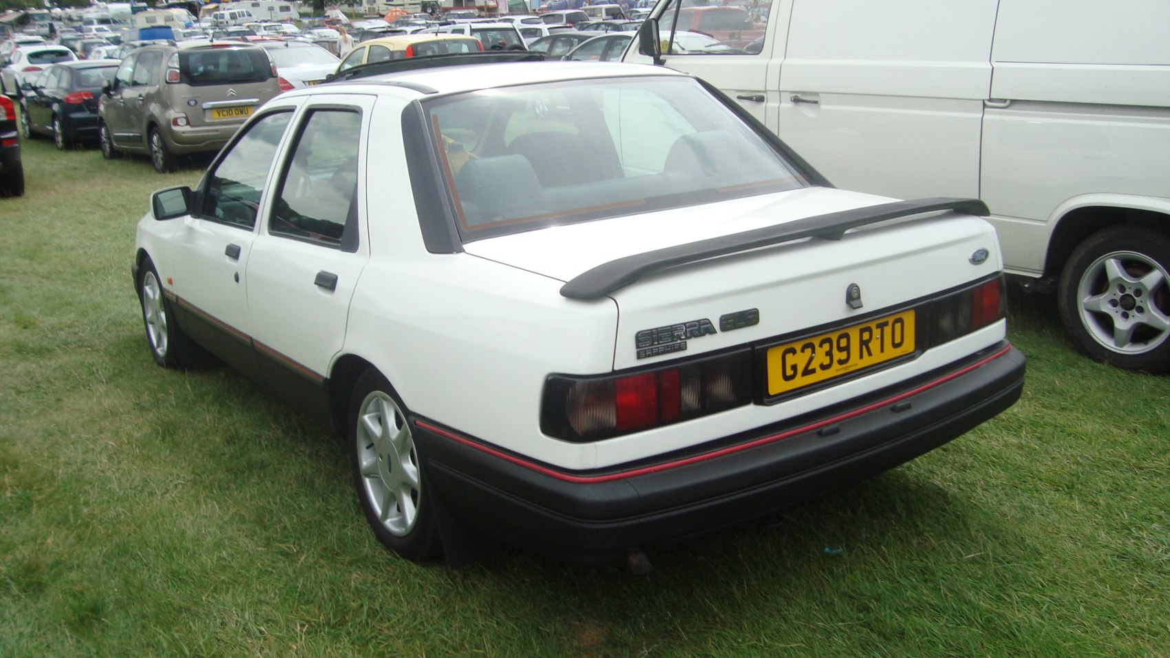 Rear view of sedan with spoiler and dark tail lights