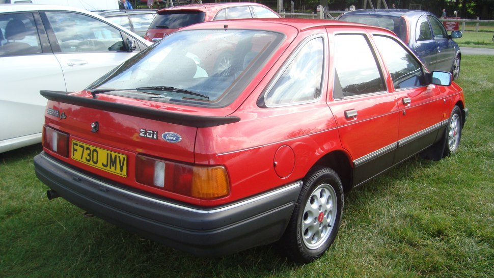 Rear view of red hatchback with spoiler and tail lights