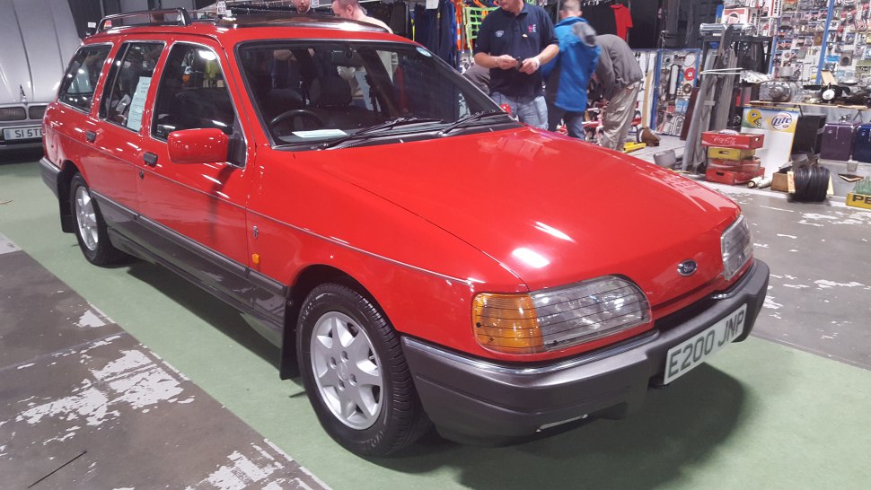 Red vintage station wagon with roof rails and rectangular headlights