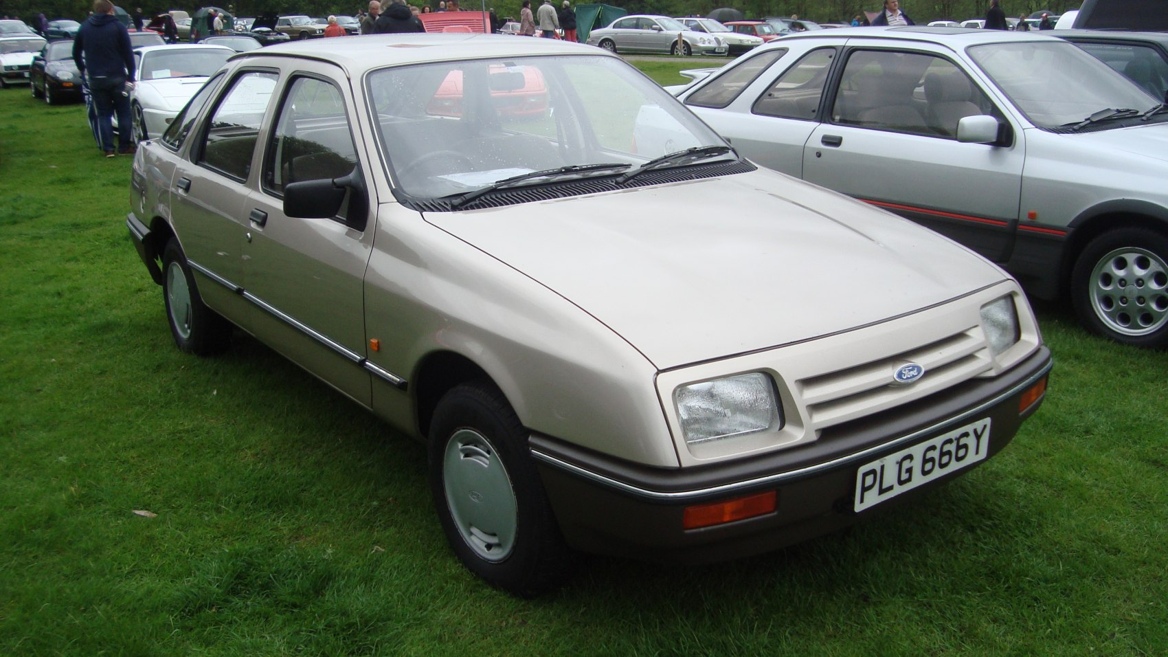 1980s compact sedan with rectangular headlights and chrome trim