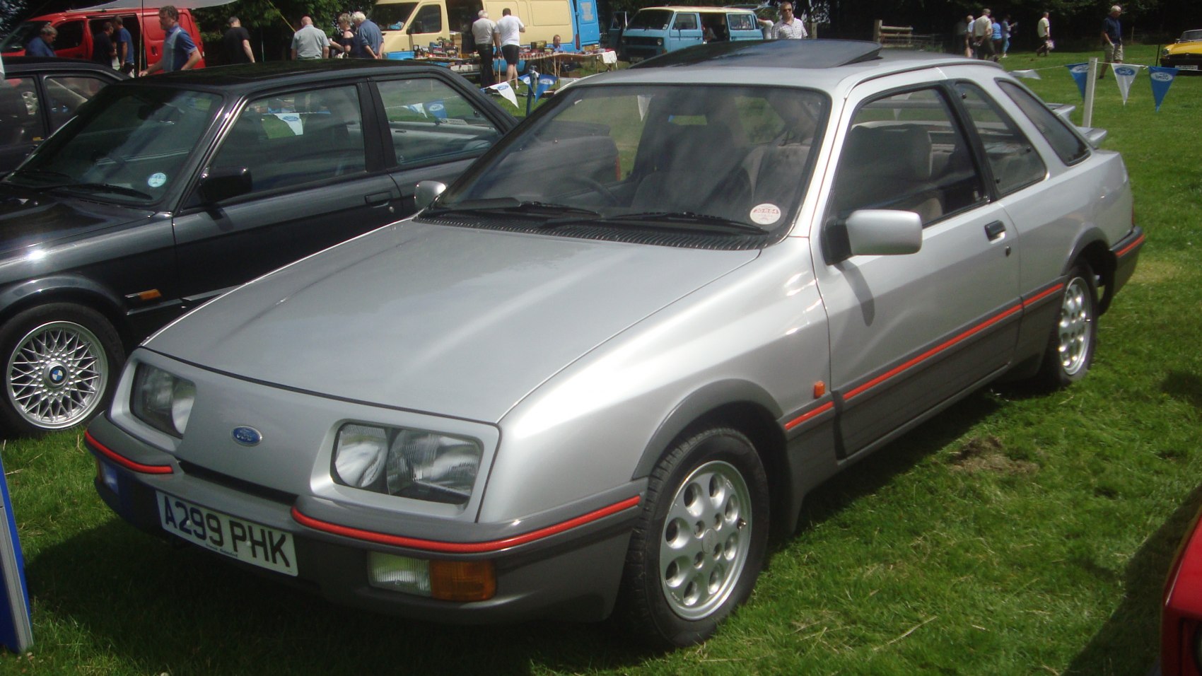 Rectangular headlights, red trim, alloy wheels, two-door hatchback