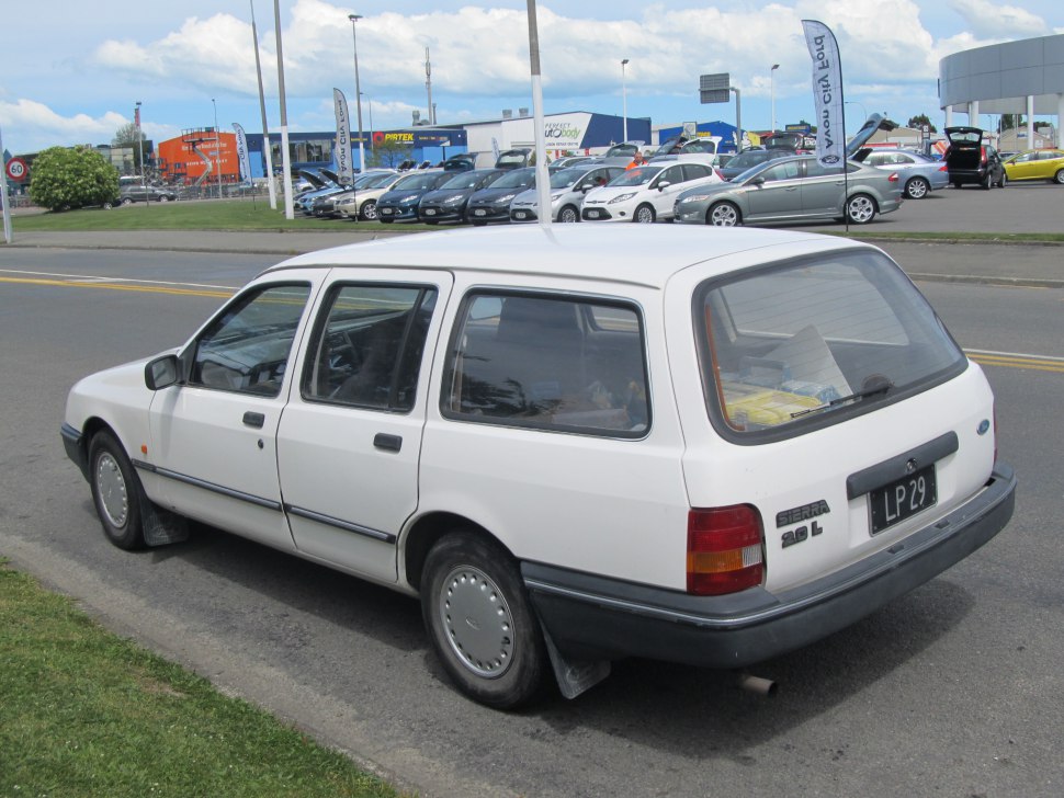 Rear side view of a boxy estate car with steel wheels and a large rear window.