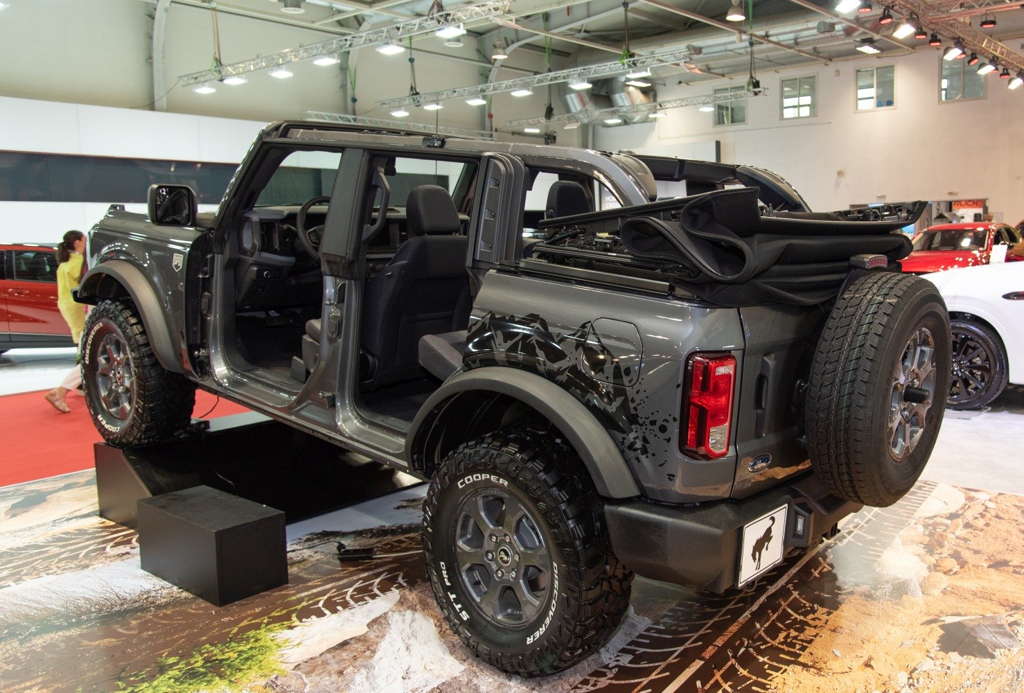 Four-door SUV with offroad tires and folded soft top