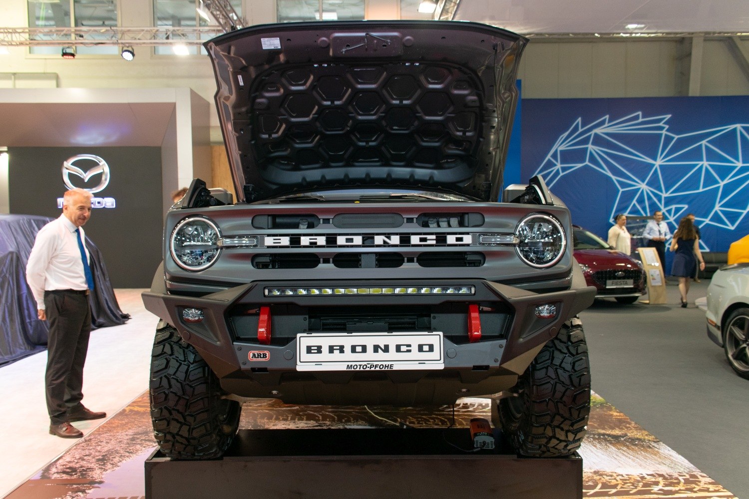 Front grille and open hood with rugged off-road tires