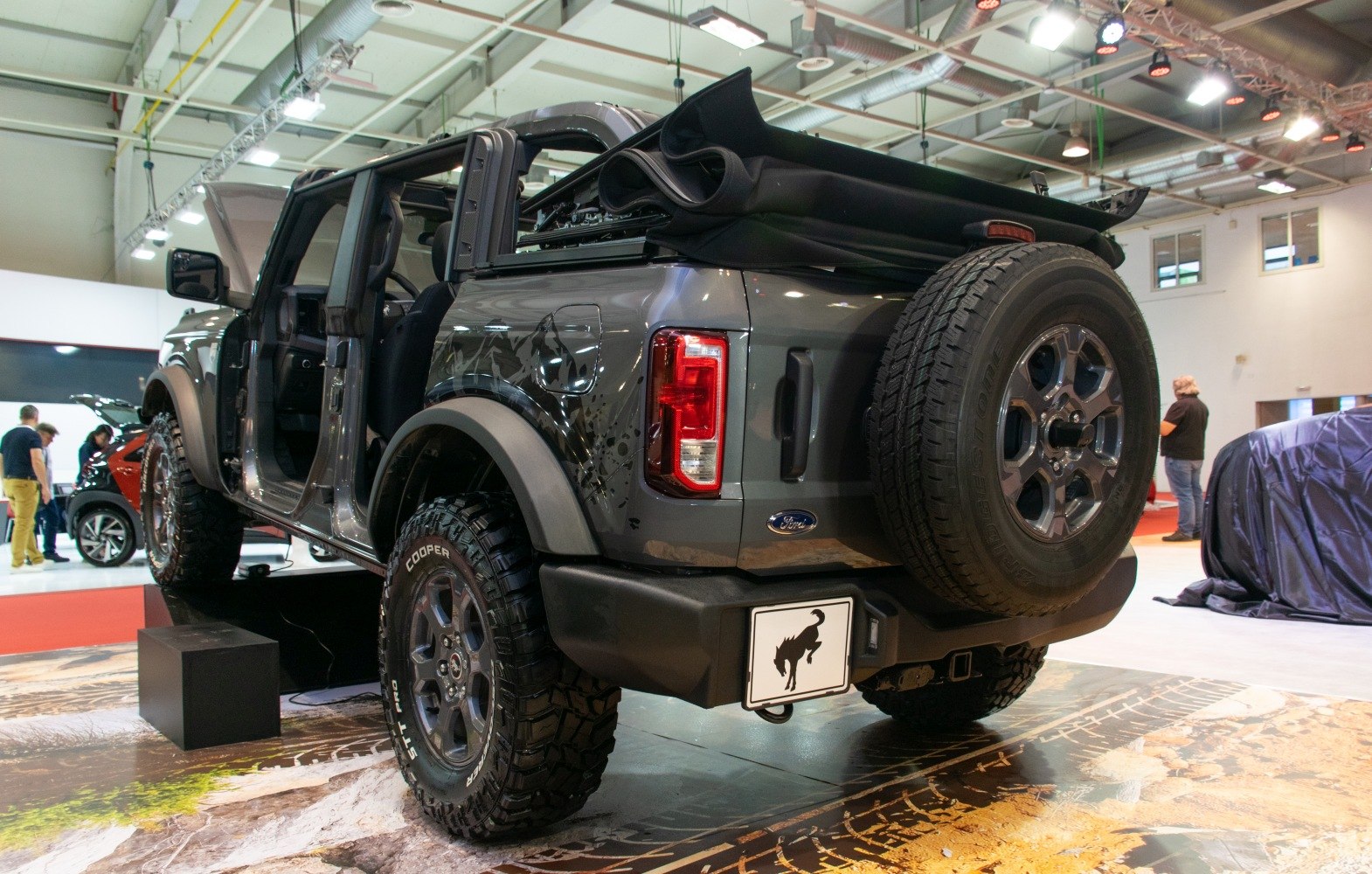 Off-road tires and folded soft top on rugged SUV rear