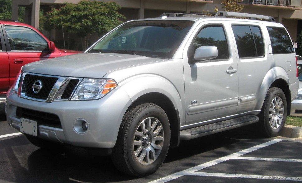 Side profile of silver SUV with running boards and alloy wheels