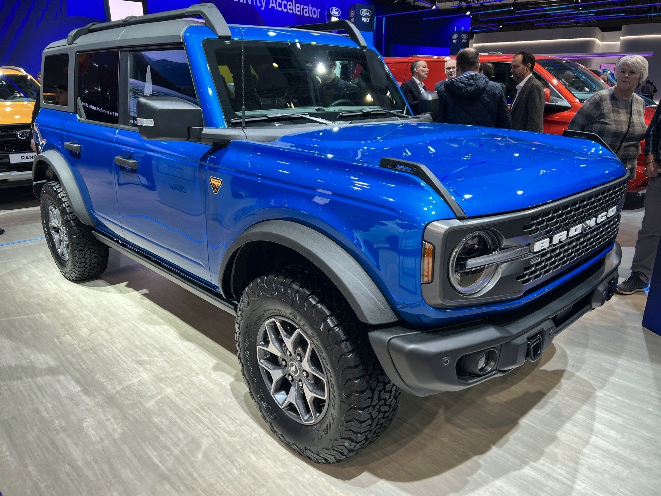 Blue four-door SUV with rugged off-road tires and bold front grille