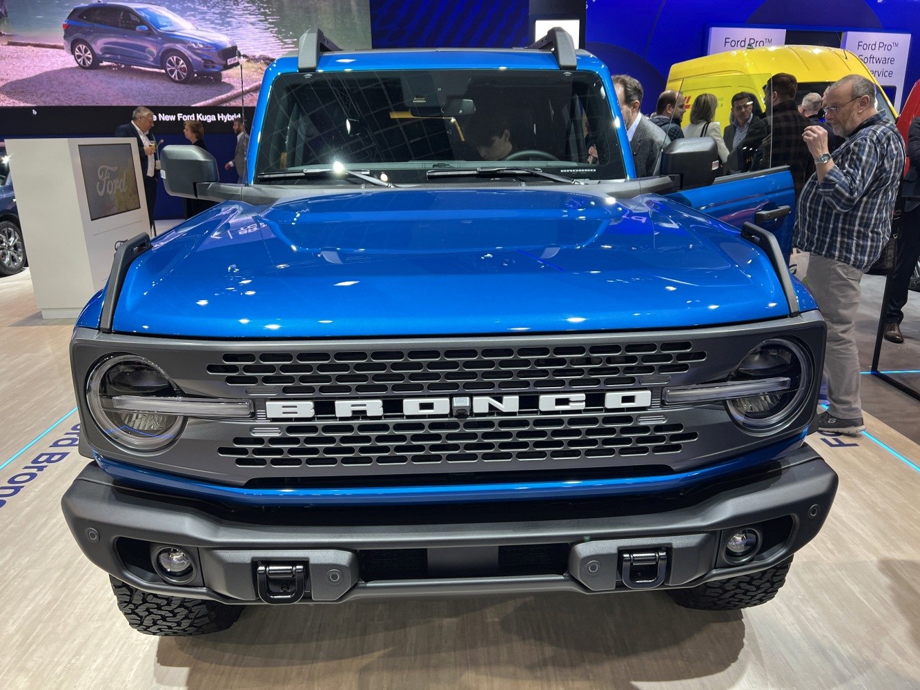 Front grille and round headlights of blue four-door SUV