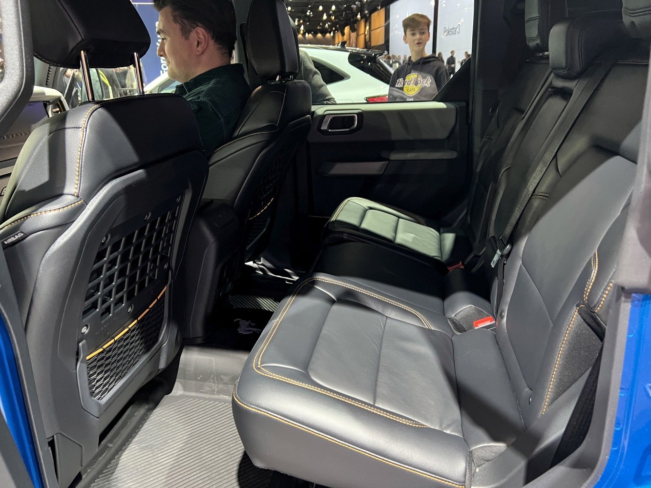 Spacious rear seats with premium black leather upholstery and storage nets