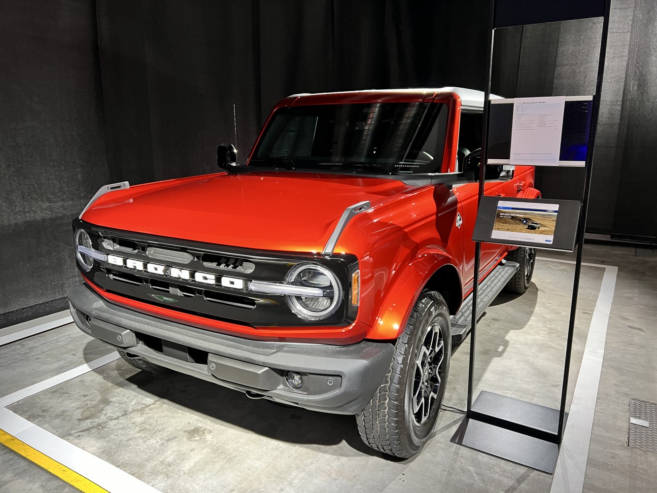 Red off-road SUV with circular headlights and large grille.