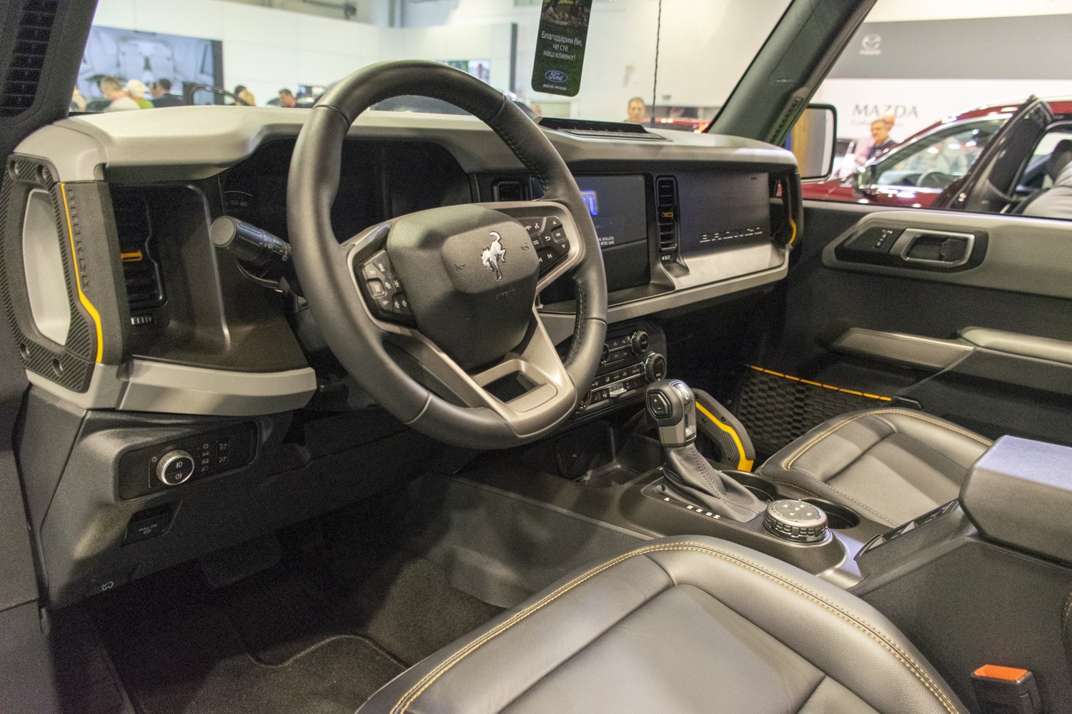 Modern dashboard and multifunction steering wheel with leather seating.