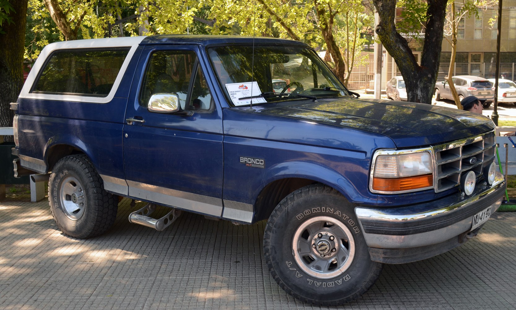 Blue off-road SUV with chrome grille and rugged tires