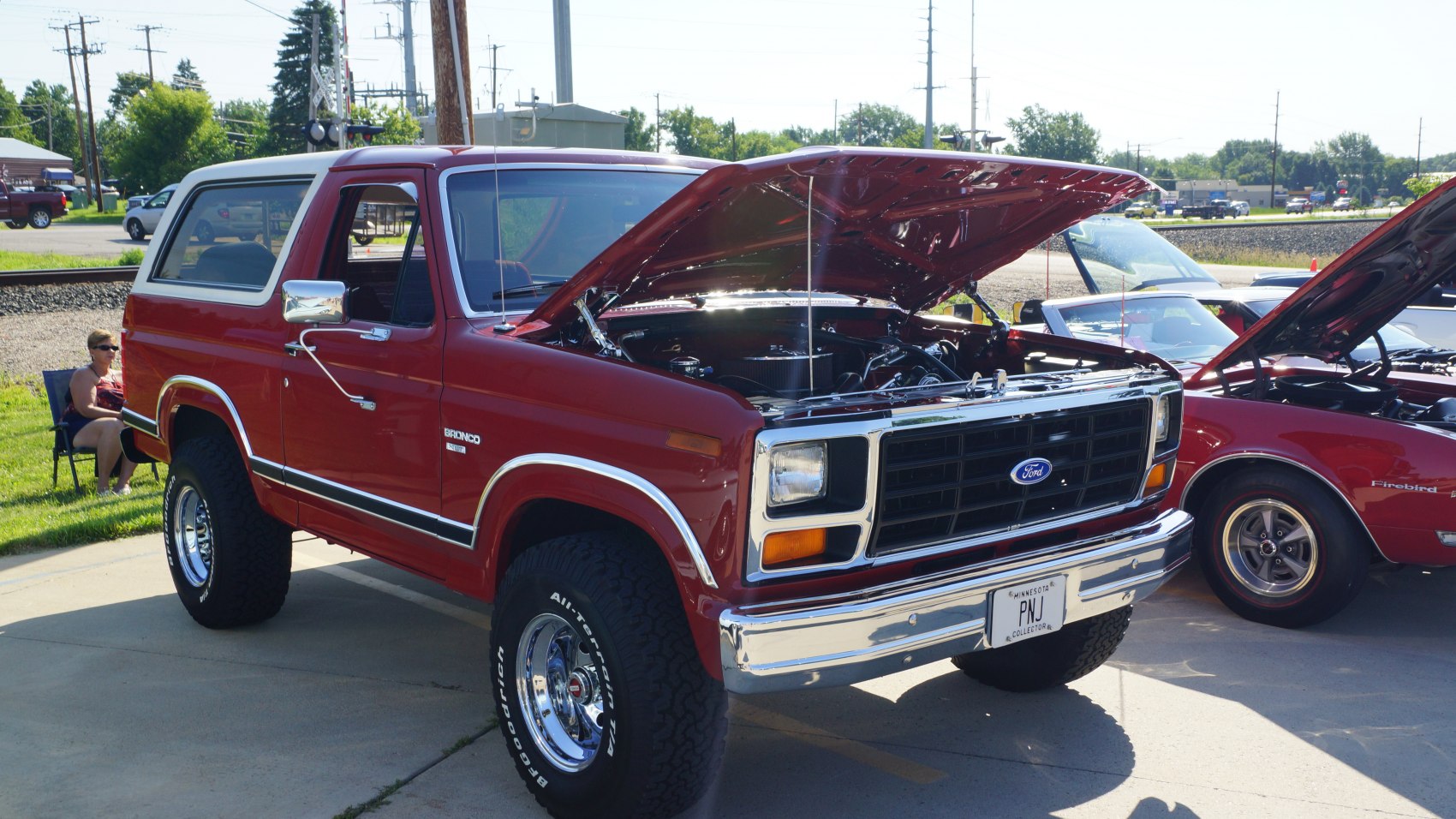 Boxy SUV with open hood, low profile tires, and chrome accents.