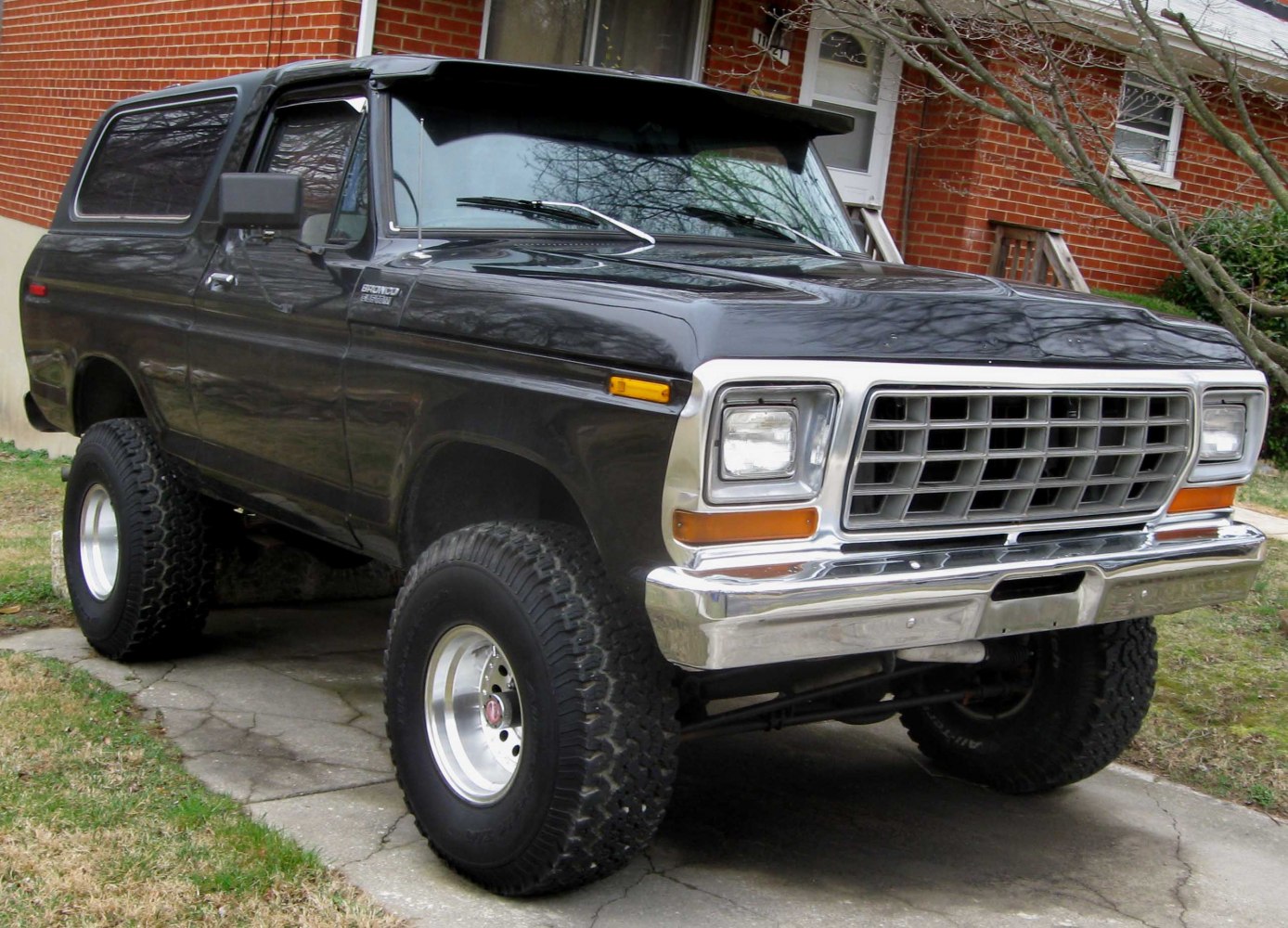 Vintage SUV with chrome grille and large off-road tires