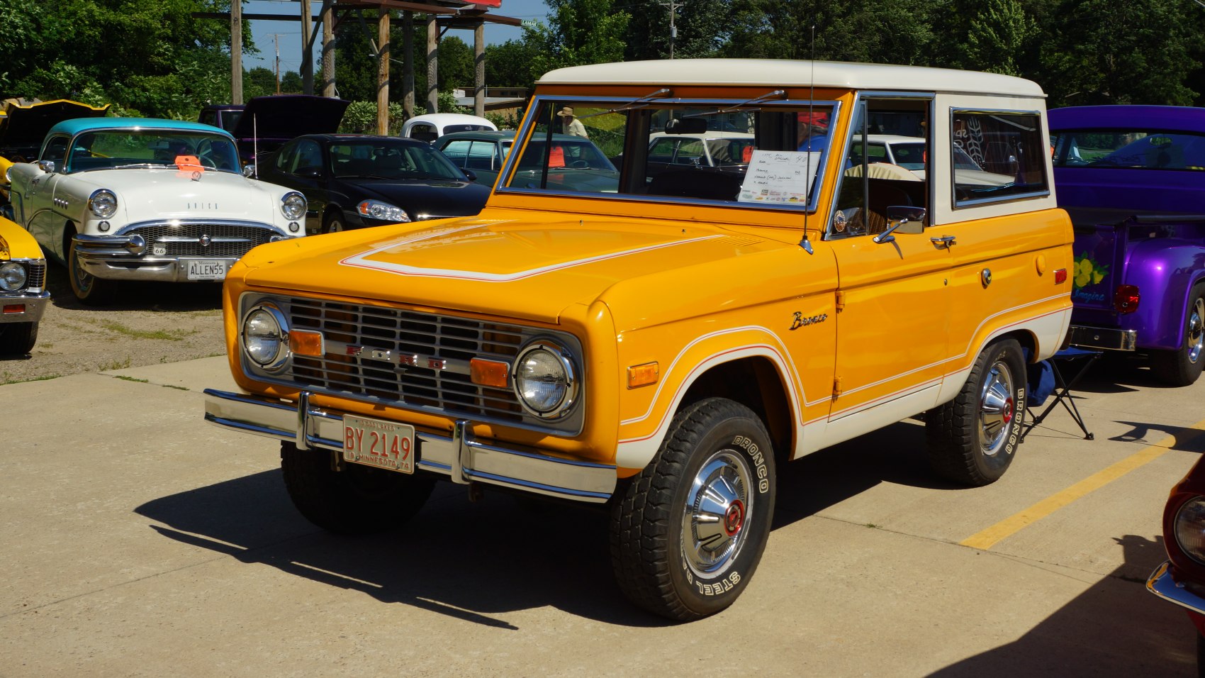 Vintage SUV with round headlights and chrome bumpers in two-tone paint.