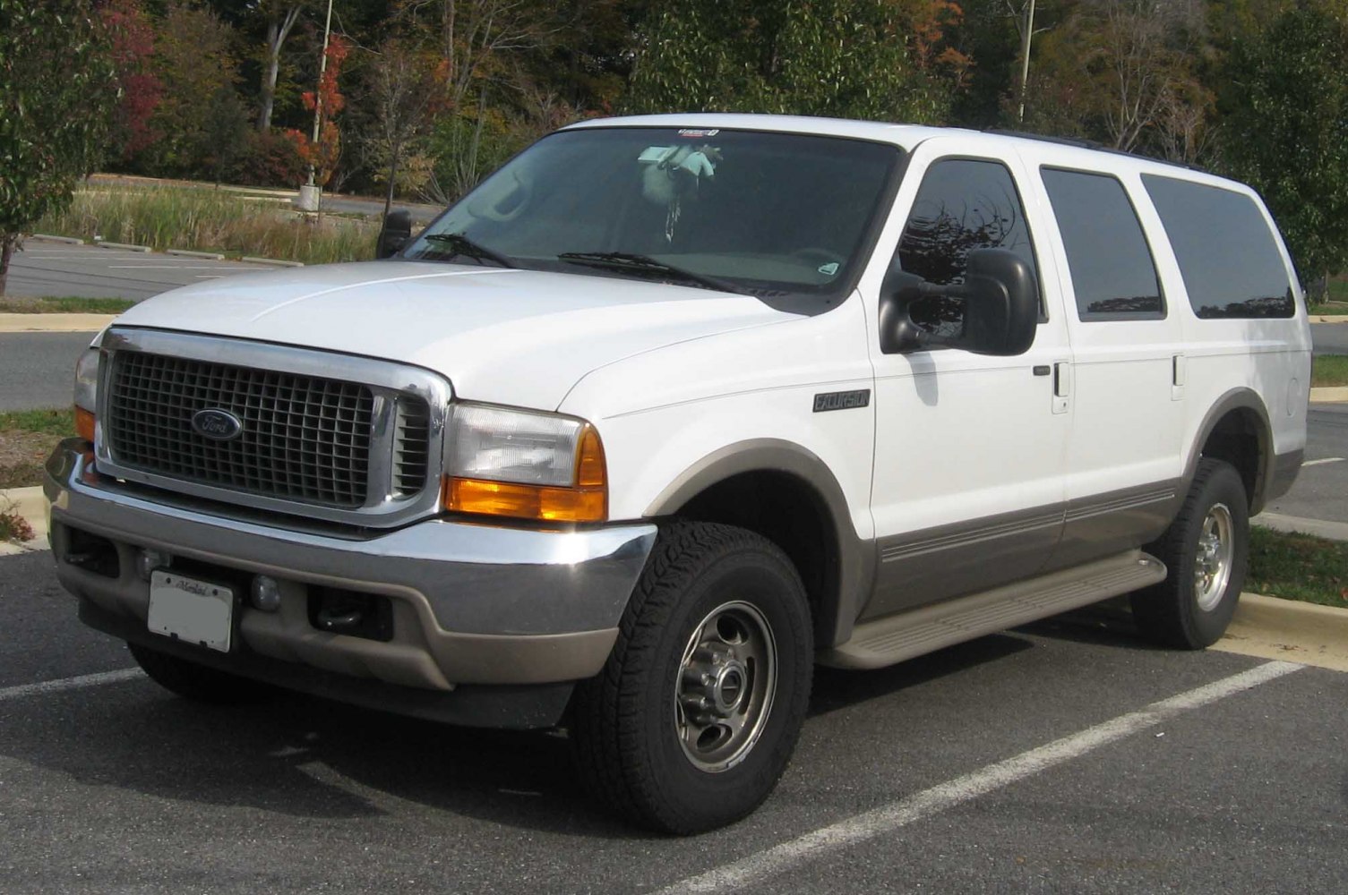 White SUV with large grille, rugged tires, and tinted rear windows