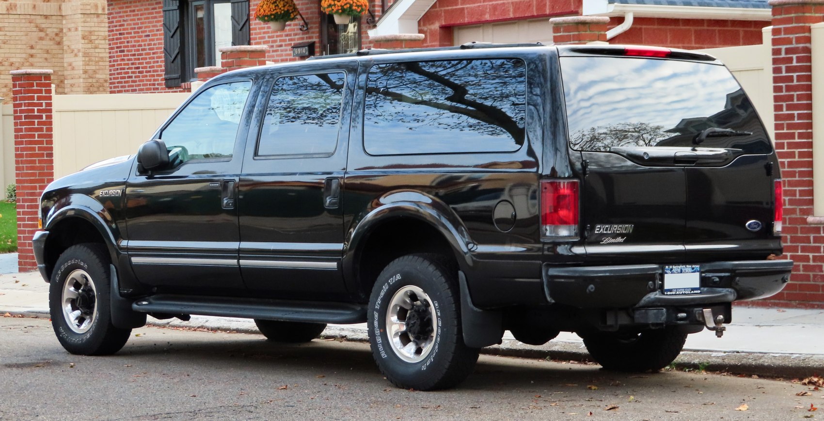 Large SUV side and rear view with off-road tires and tinted windows