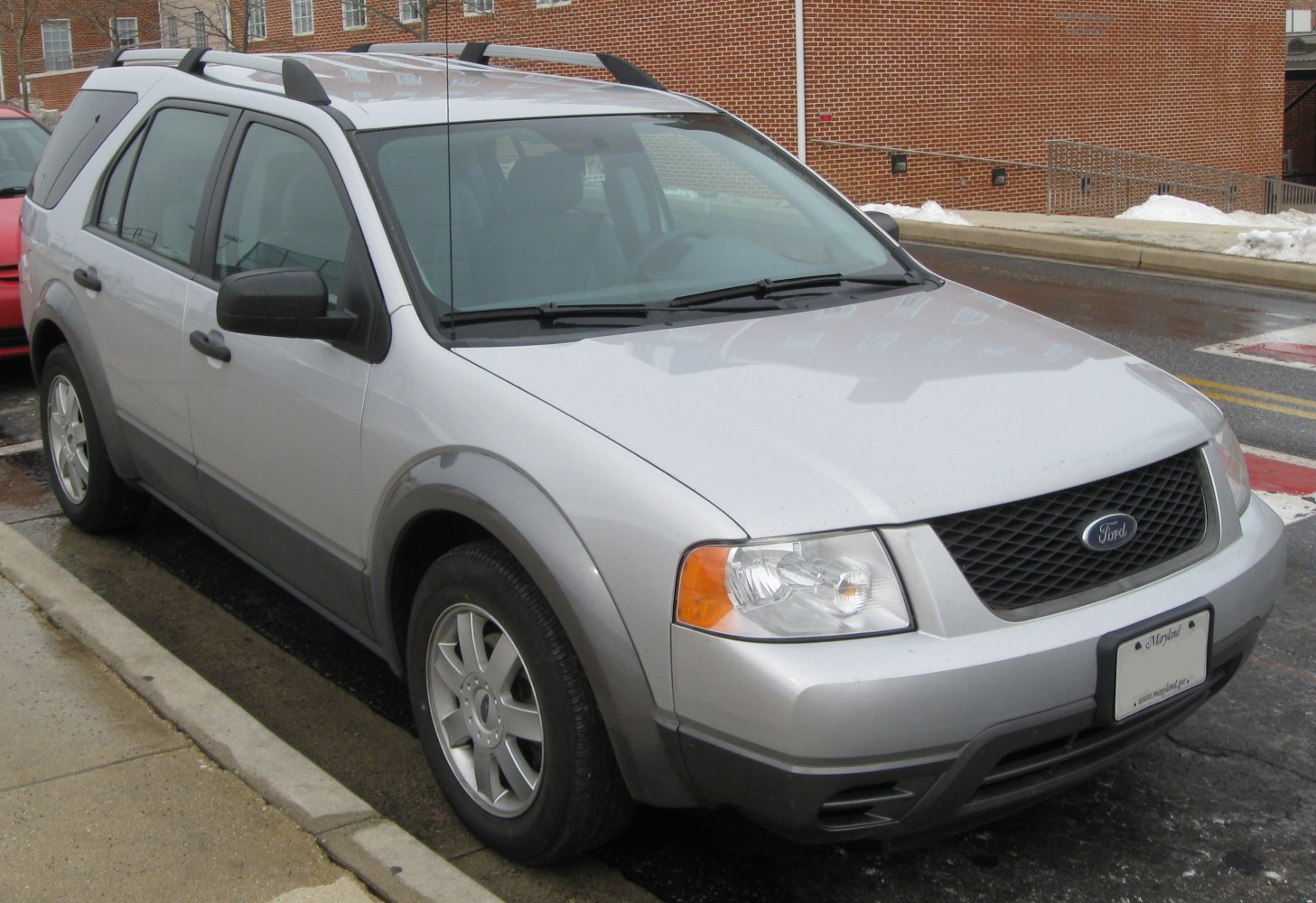 Silver SUV with front grill, headlights and roof rails