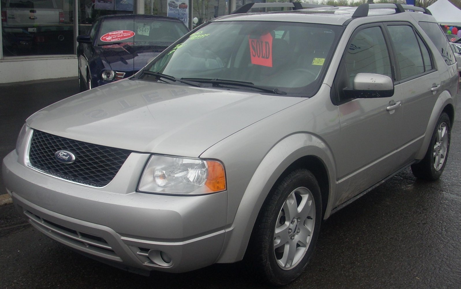 Silver SUV with front 3/4 view showing grille and headlights