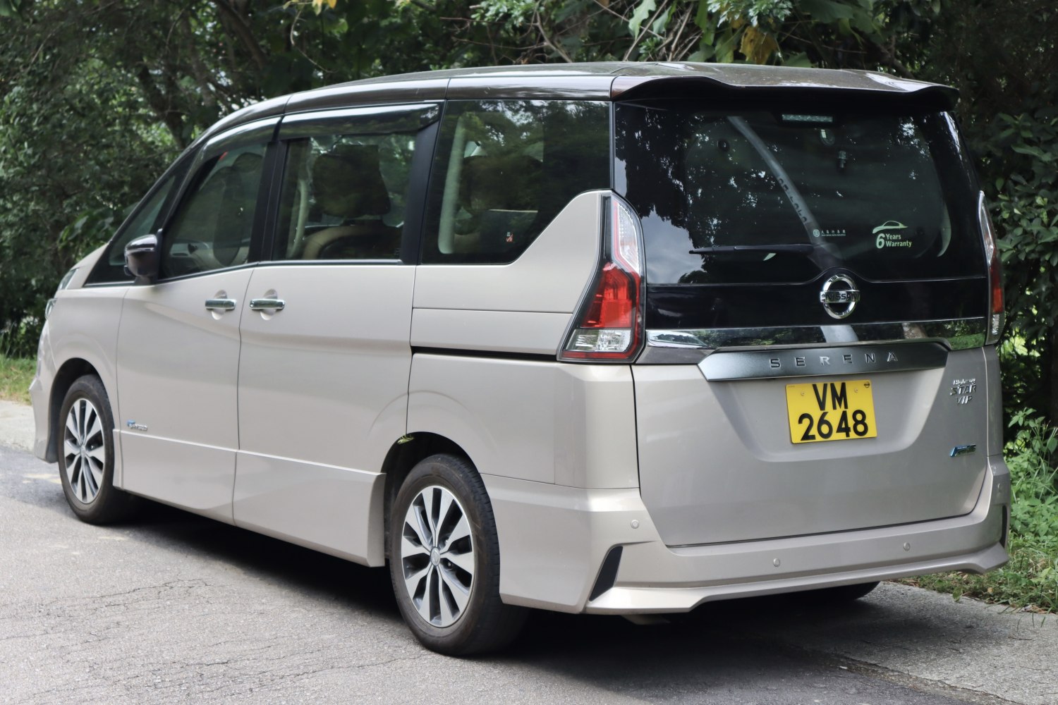 Rear and side view of a minivan with sliding doors and vertical taillights