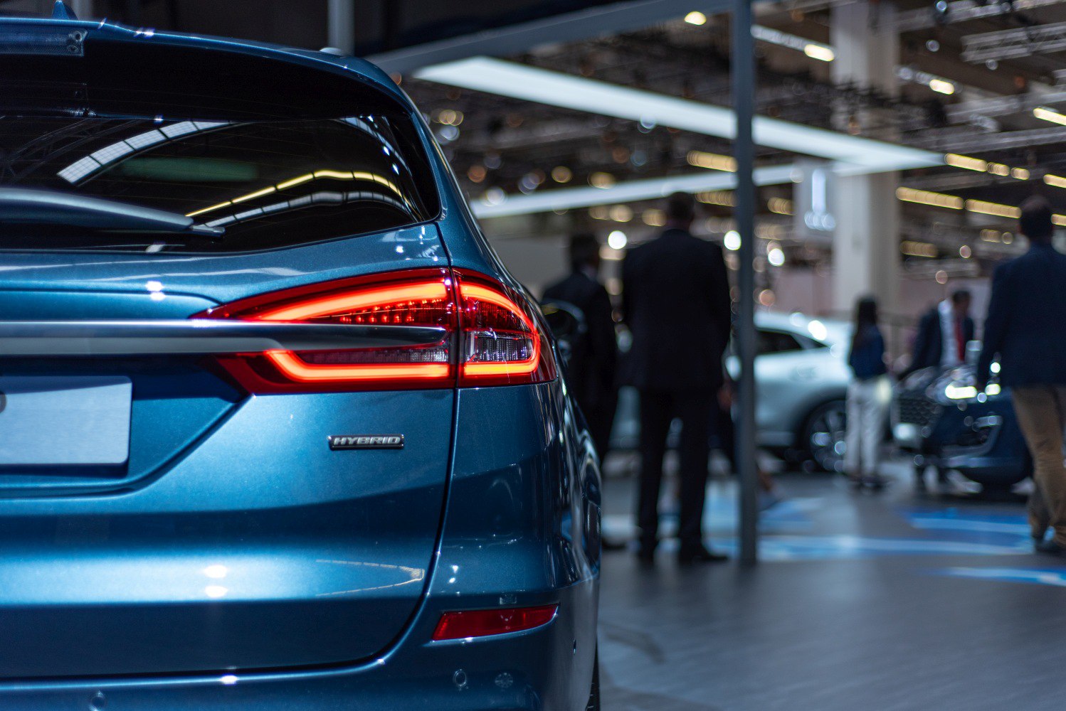 Close-up of hybrid rear lights and badge on a blue wagon.