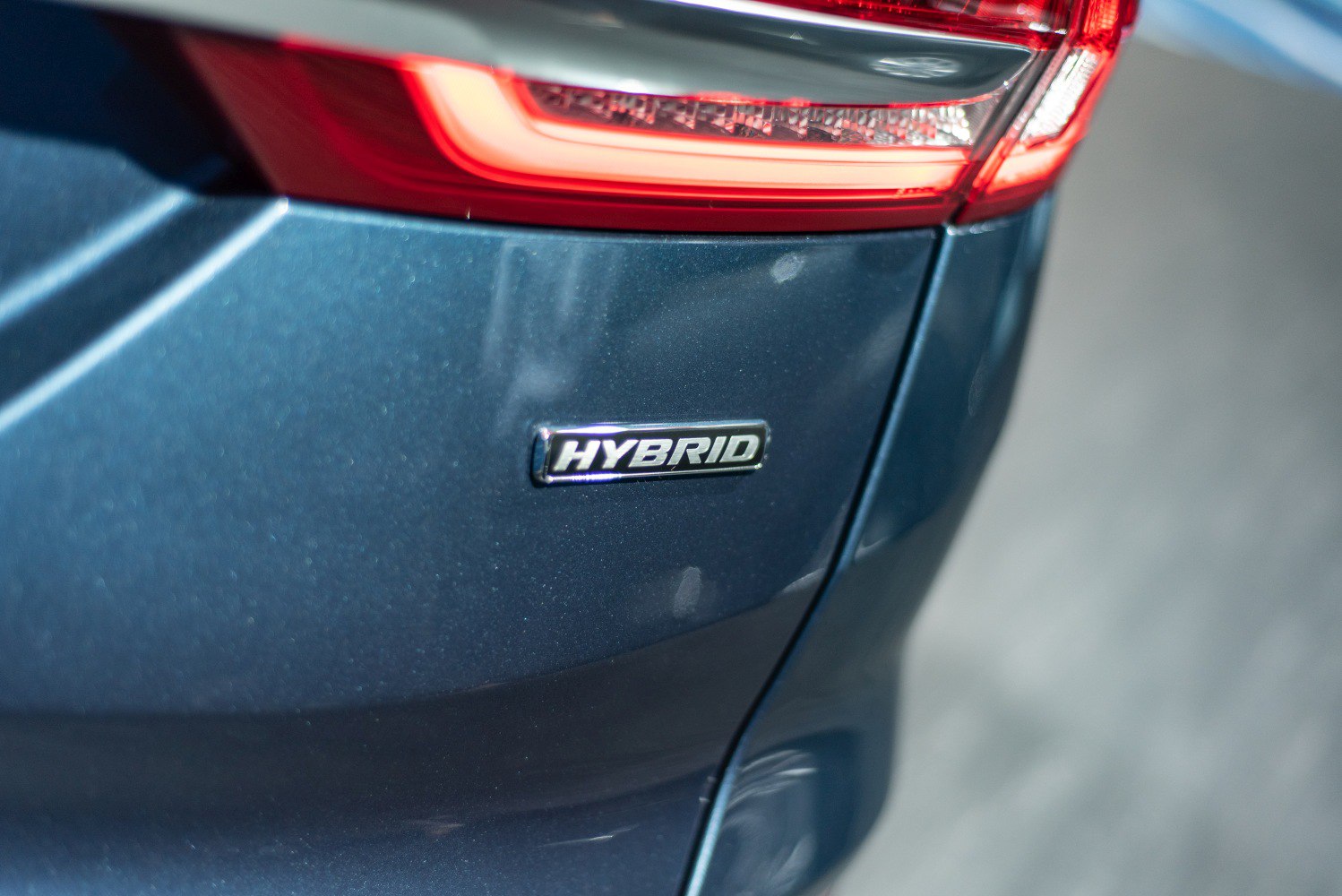 Close-up of hybrid badge and rear taillight section