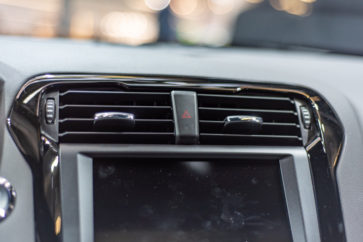 Central air vents with hazard light control on car dashboard