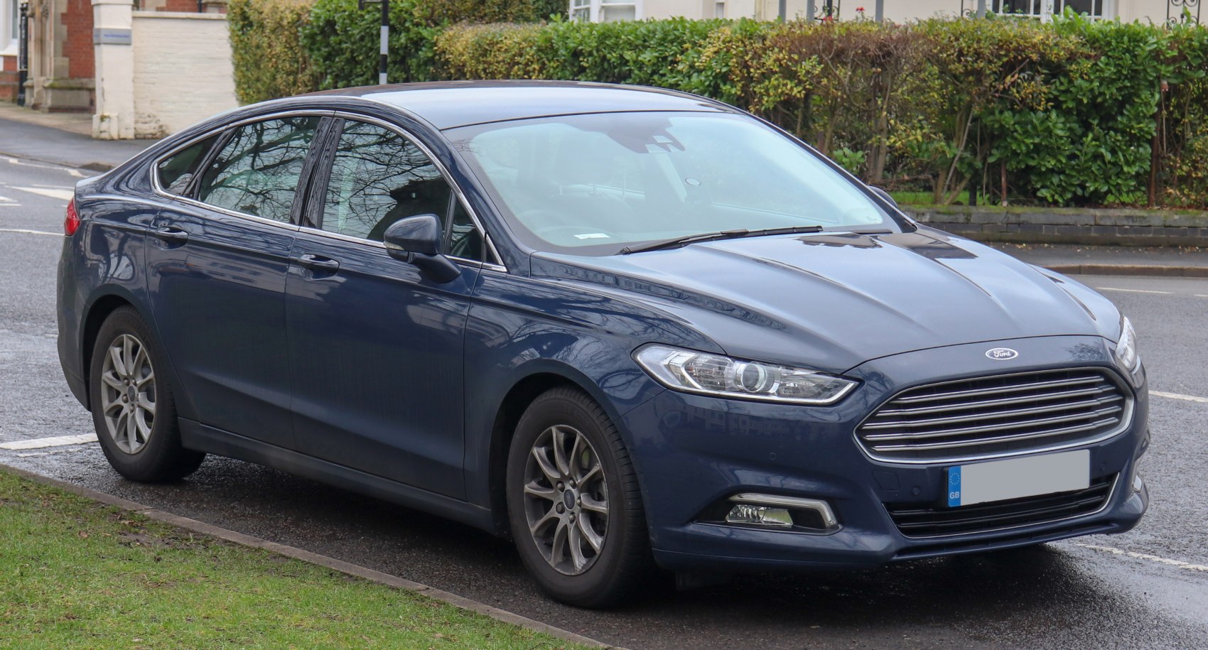 Front-side view with sleek headlights and prominent grille