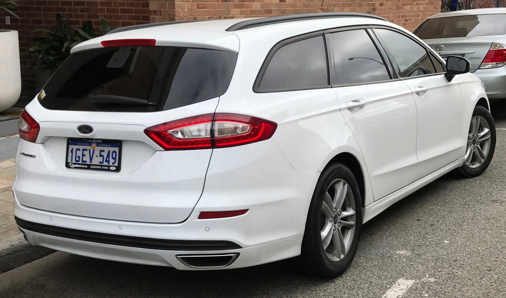 Rear and side profile of a station wagon with distinct rear lights and rear spoiler.