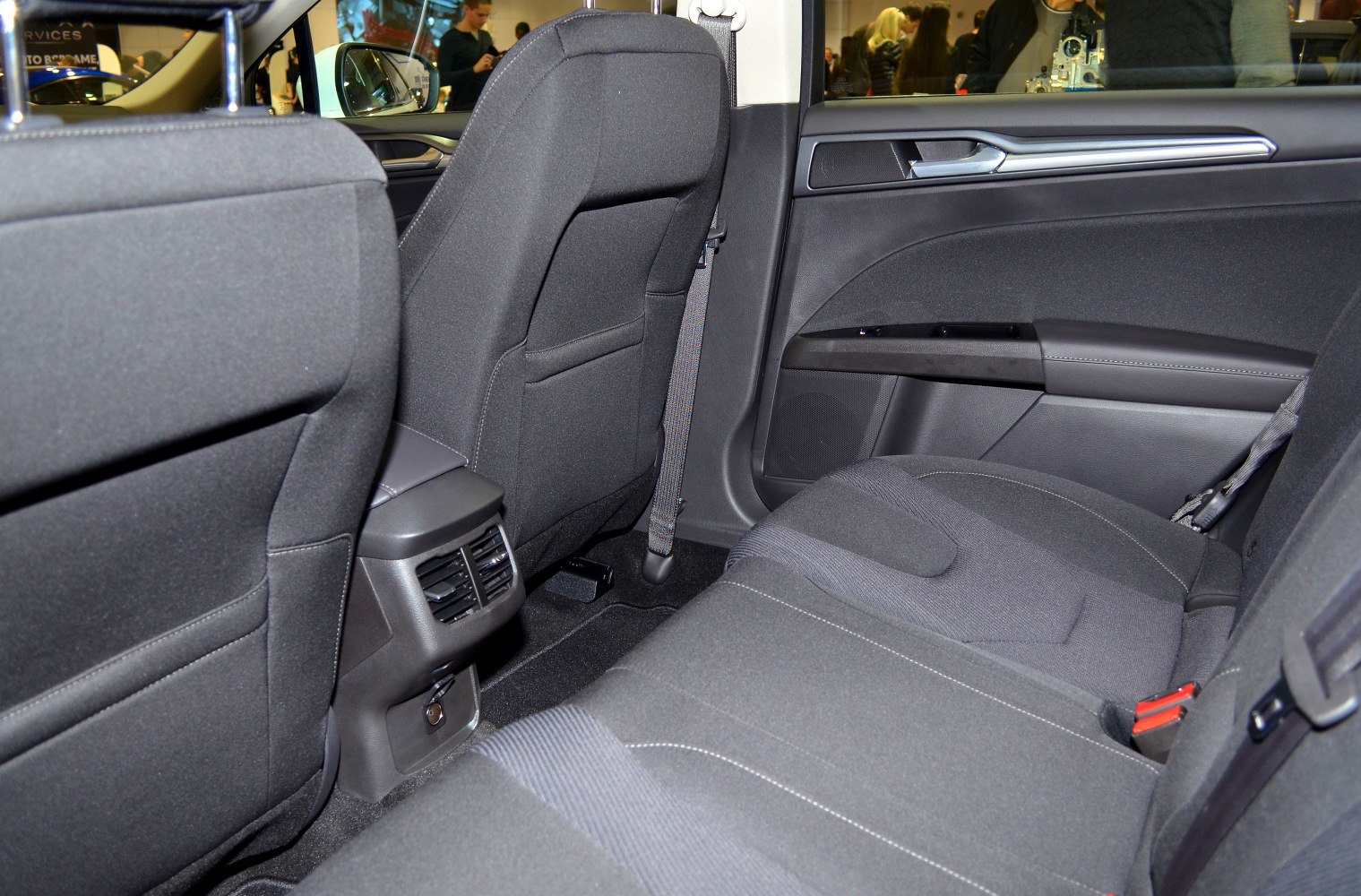 Rear seat upholstery and ventilation system with seatbelts and door trim
