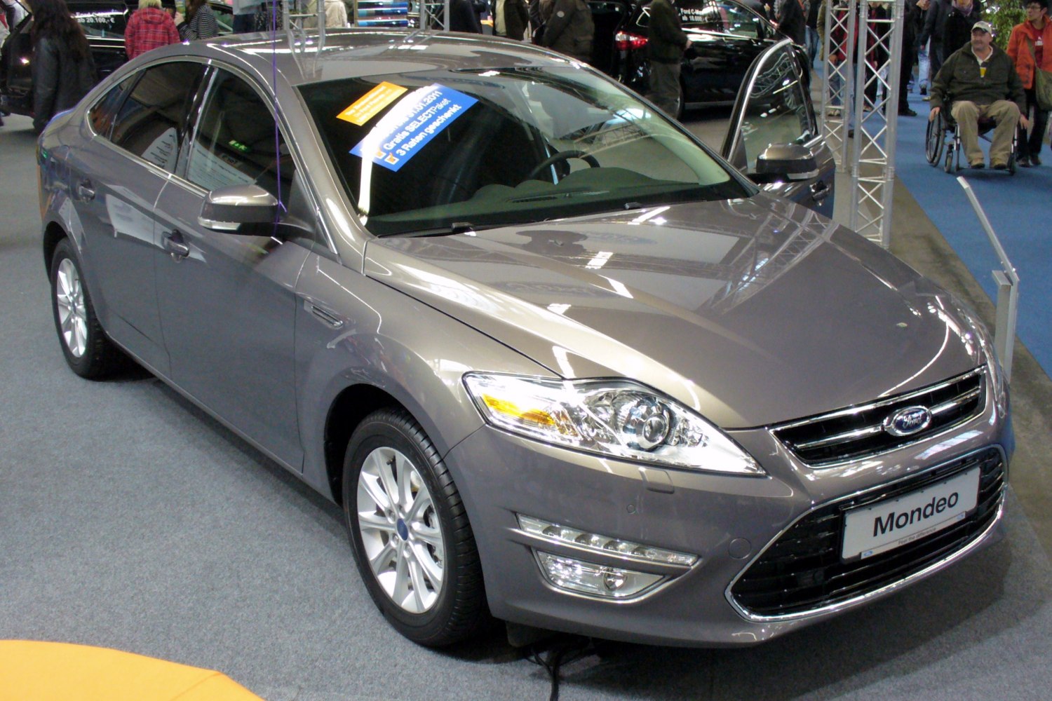 Front and side view of a modern hatchback with sleek headlights and chrome grille