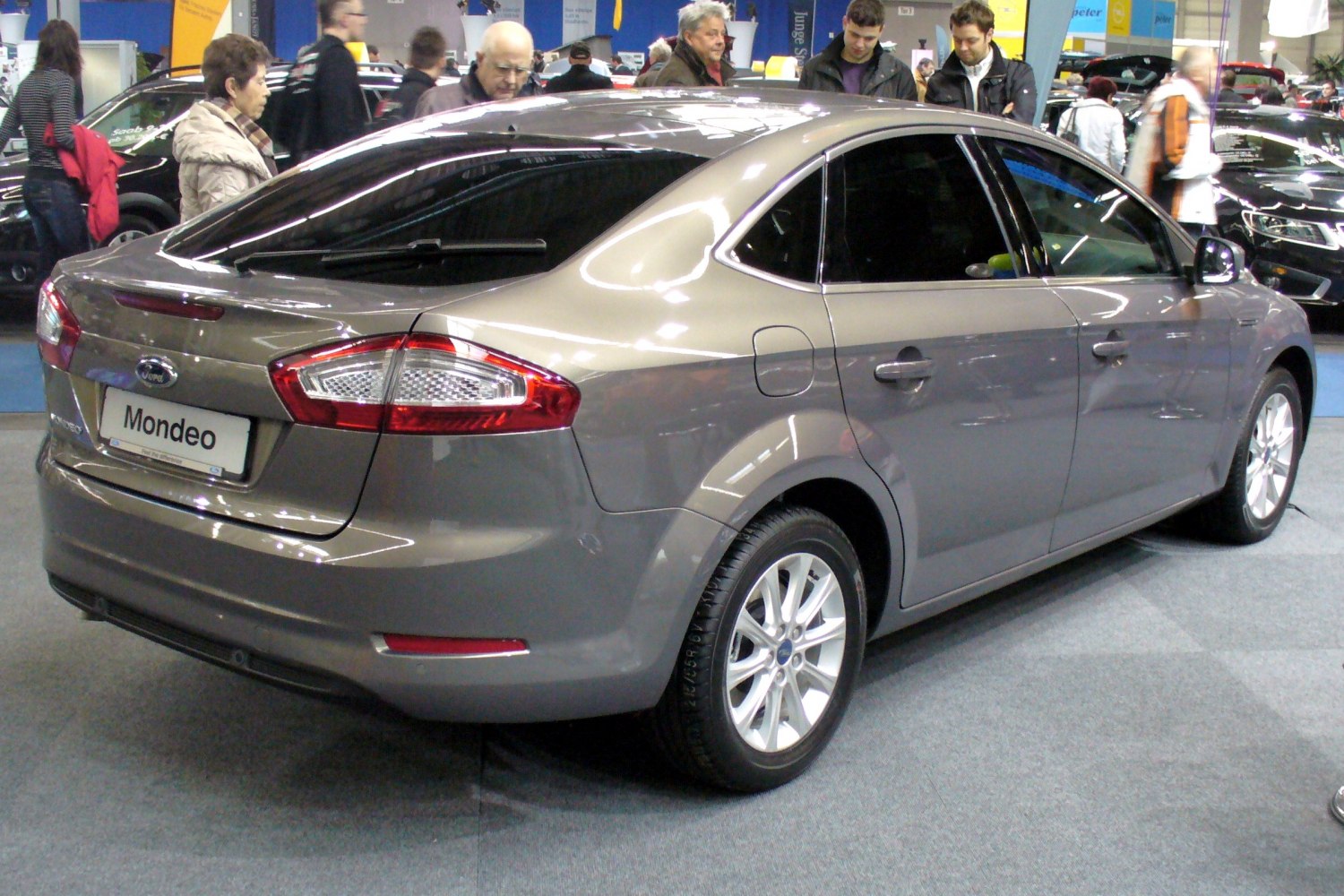 Rear side view of a gray hatchback with alloy wheels and distinctive taillights.