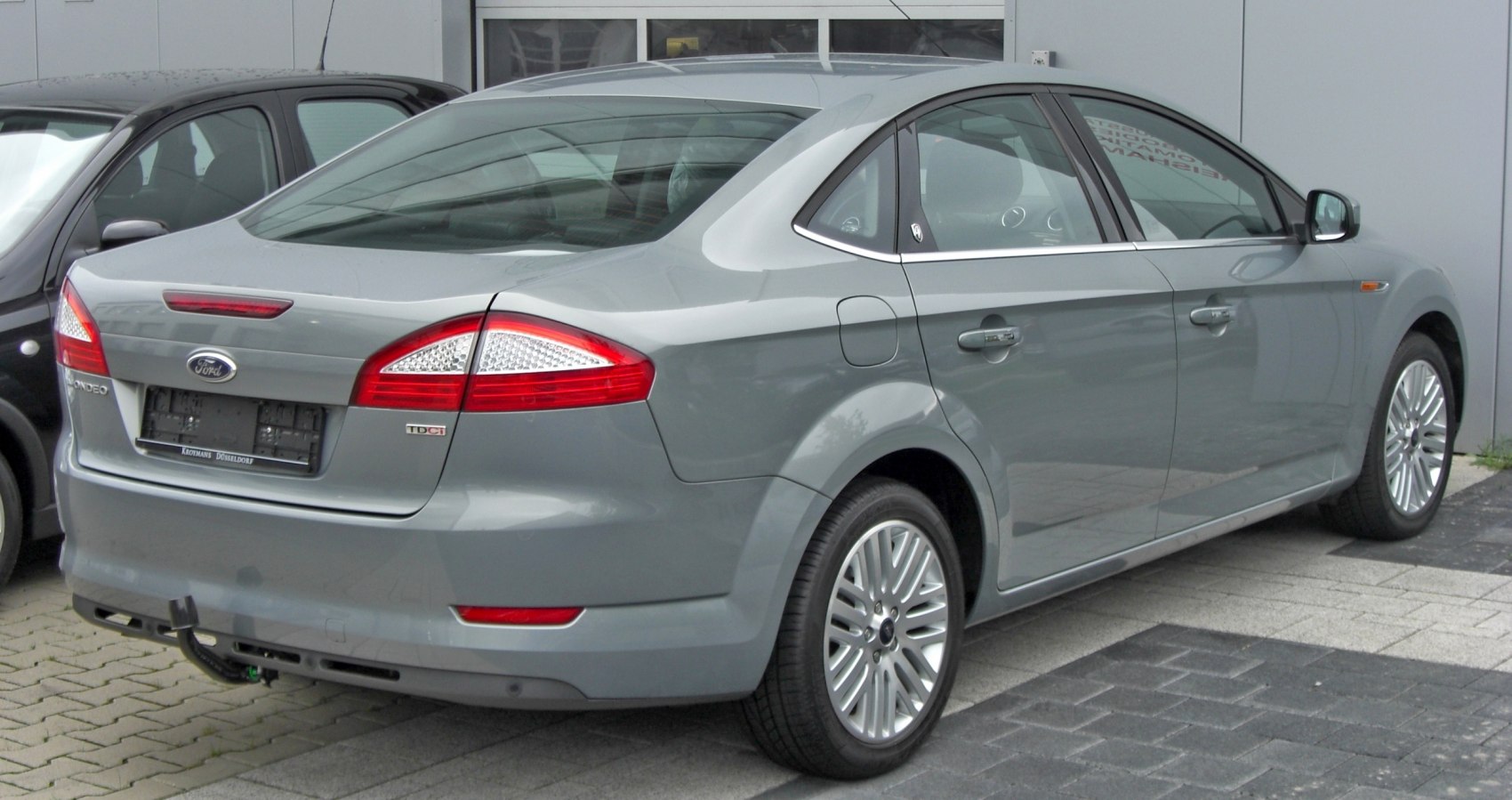 Sleek rear-side view of a sedan with distinctive tail lights and smooth body lines