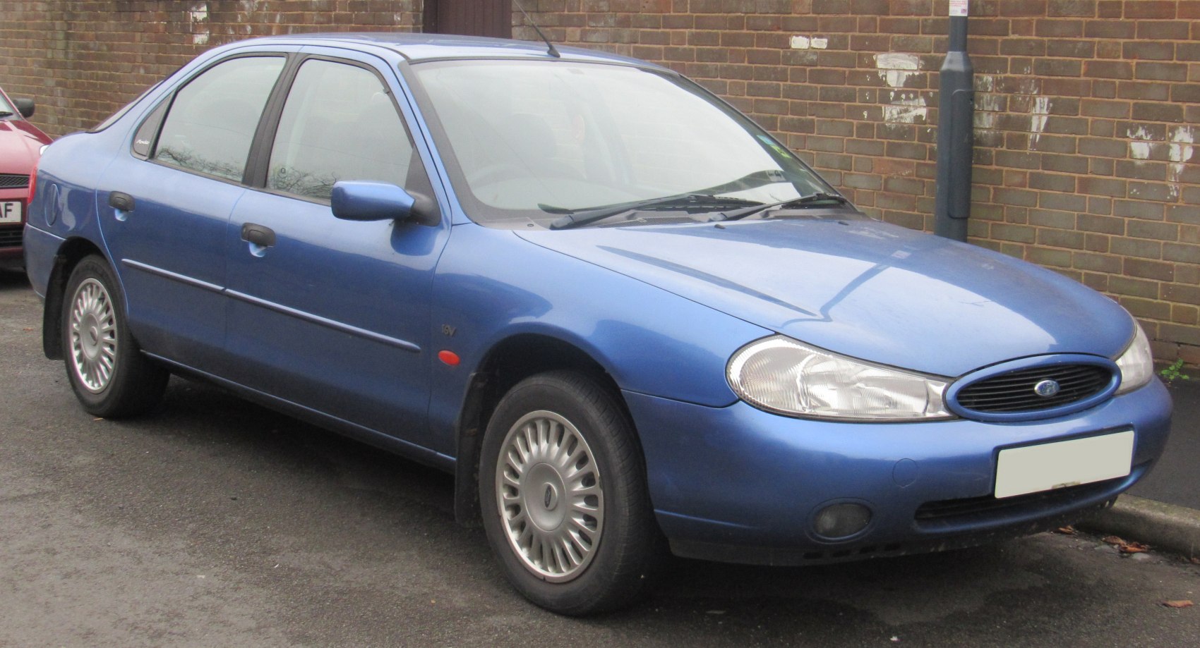 Blue hatchback with oval headlights and classic multi-spoke wheels