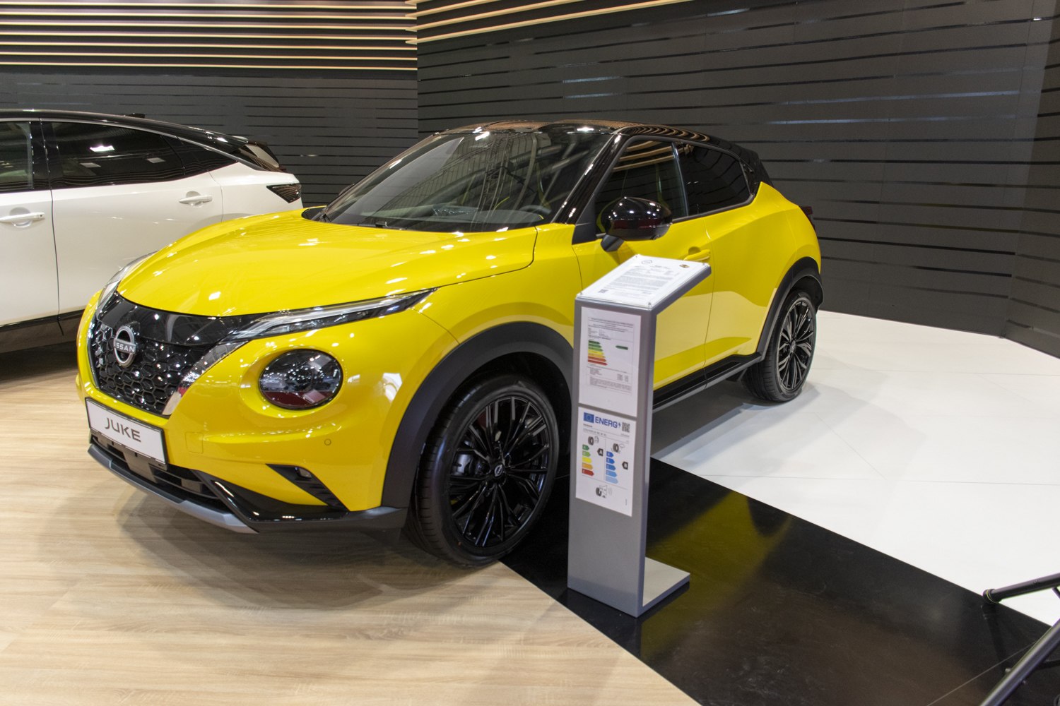 Yellow compact SUV with black roof and round headlights