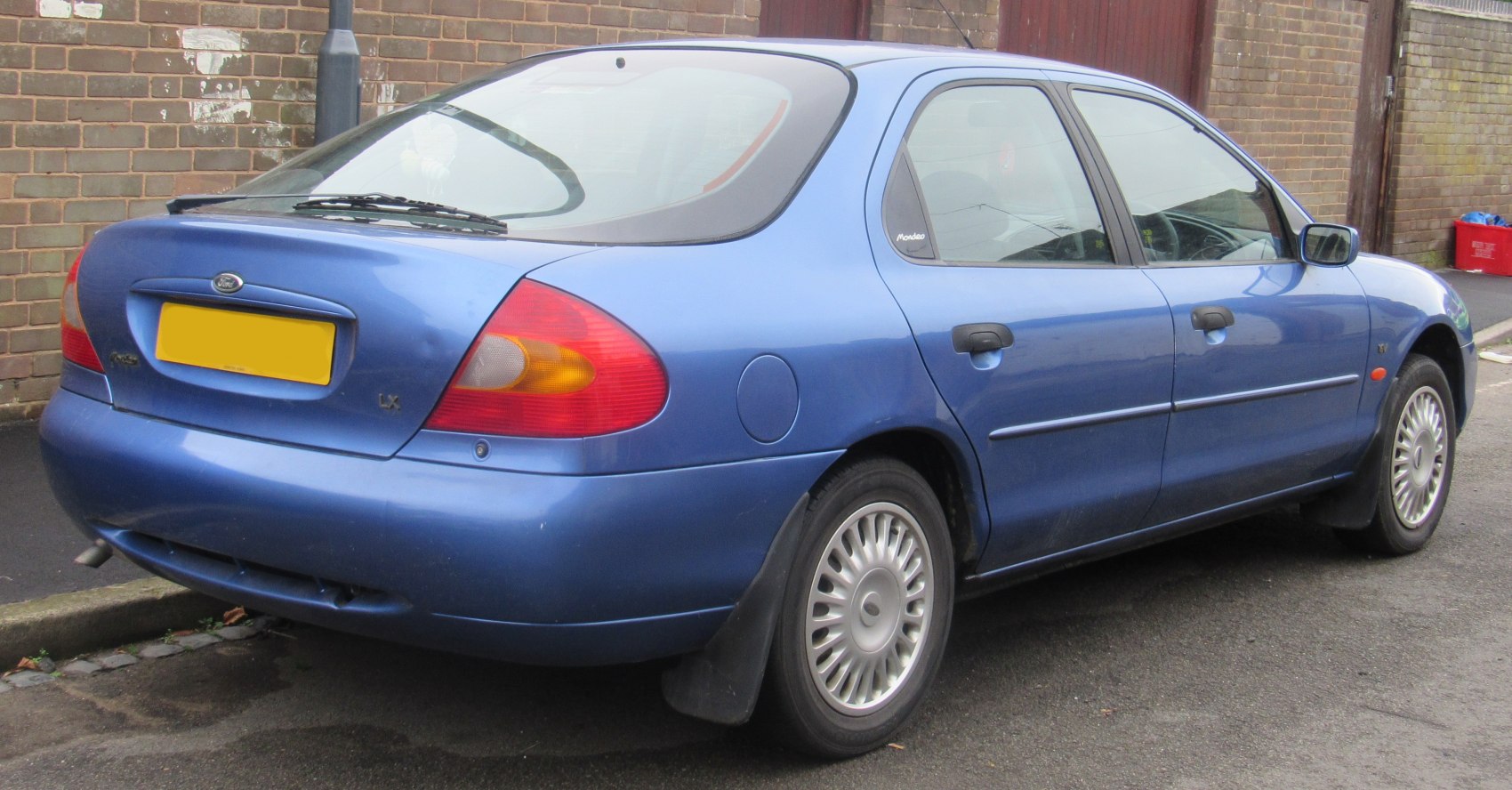 Rear side hatchback view with distinctive taillights and alloy wheels
