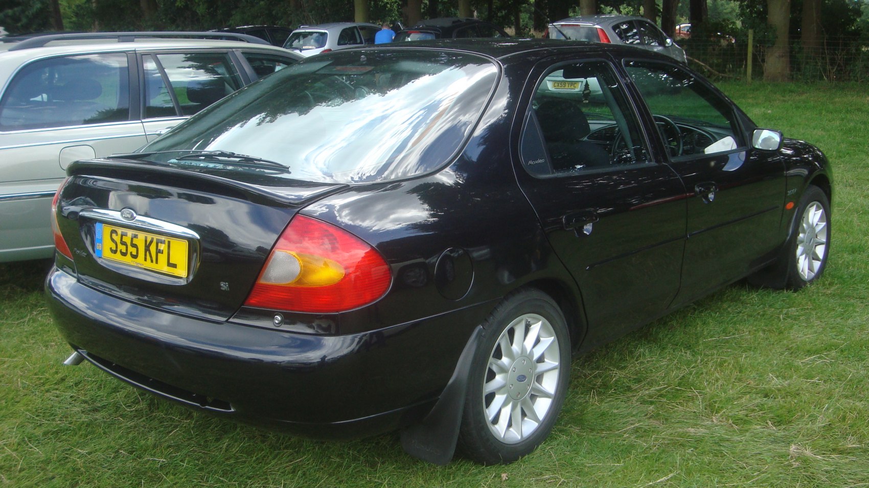 Rear three-quarter view showing tail lights and alloy wheels on black hatchback