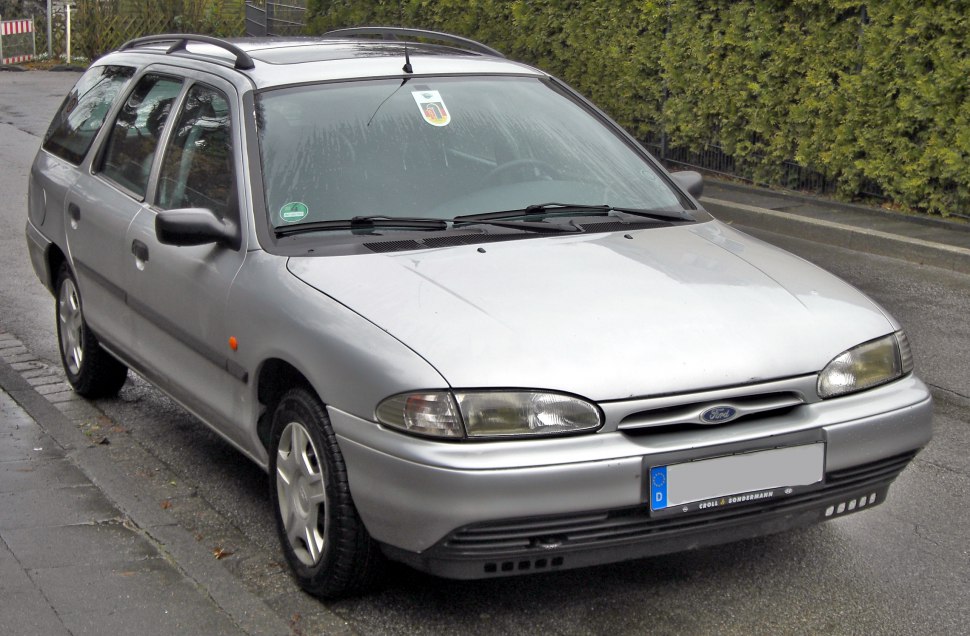 Classic silver station wagon with roof rails and vintage front design
