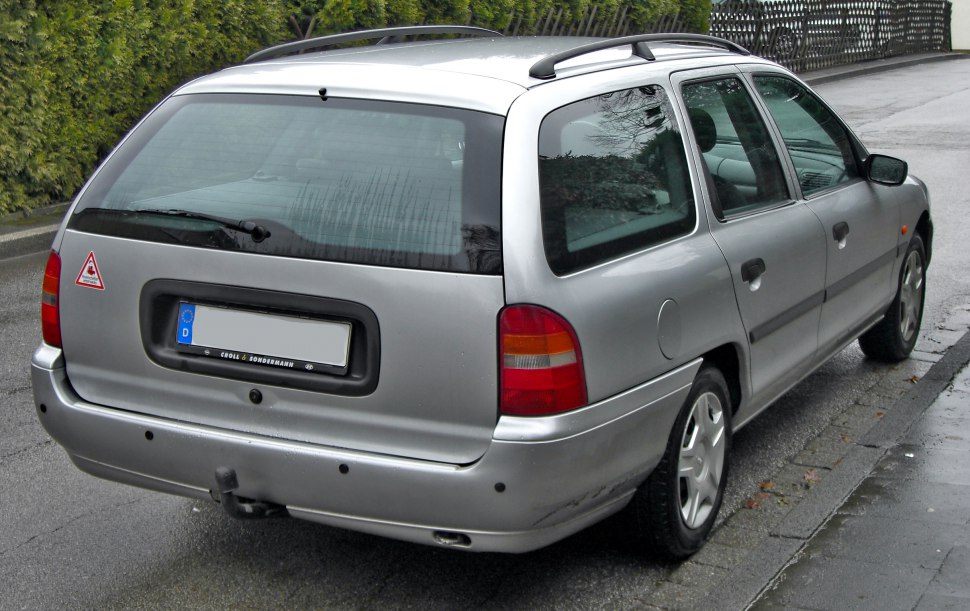 Rear view of a silver station wagon with tailgate and distinctive taillights