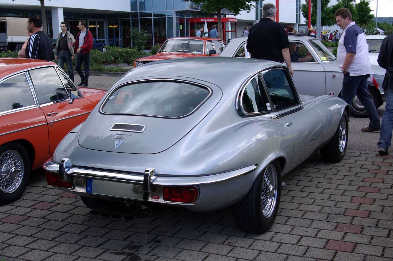 Rear view of classic coupe with smooth curves and chrome bumper
