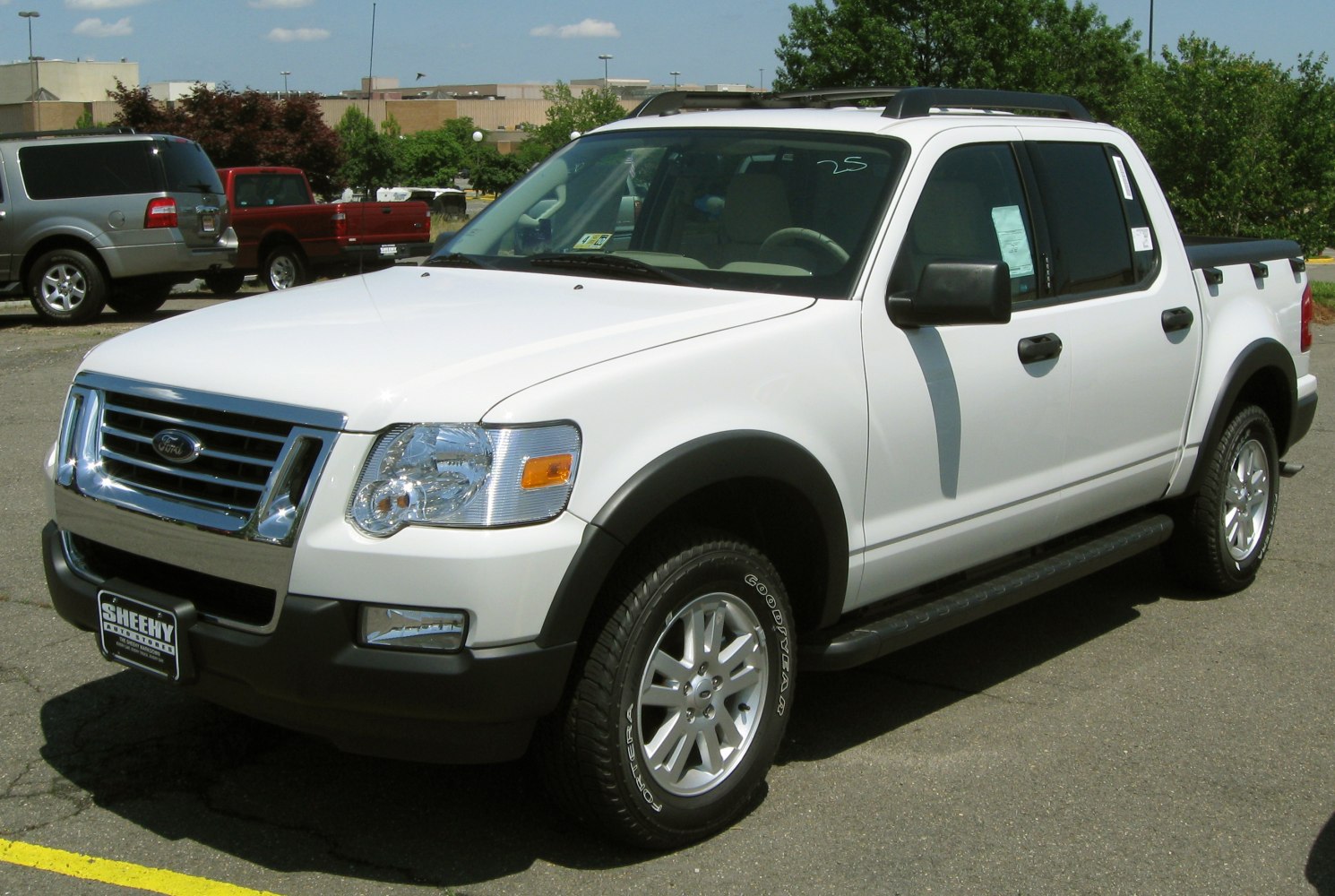 White mid-size pickup truck with double cabin and chrome grille