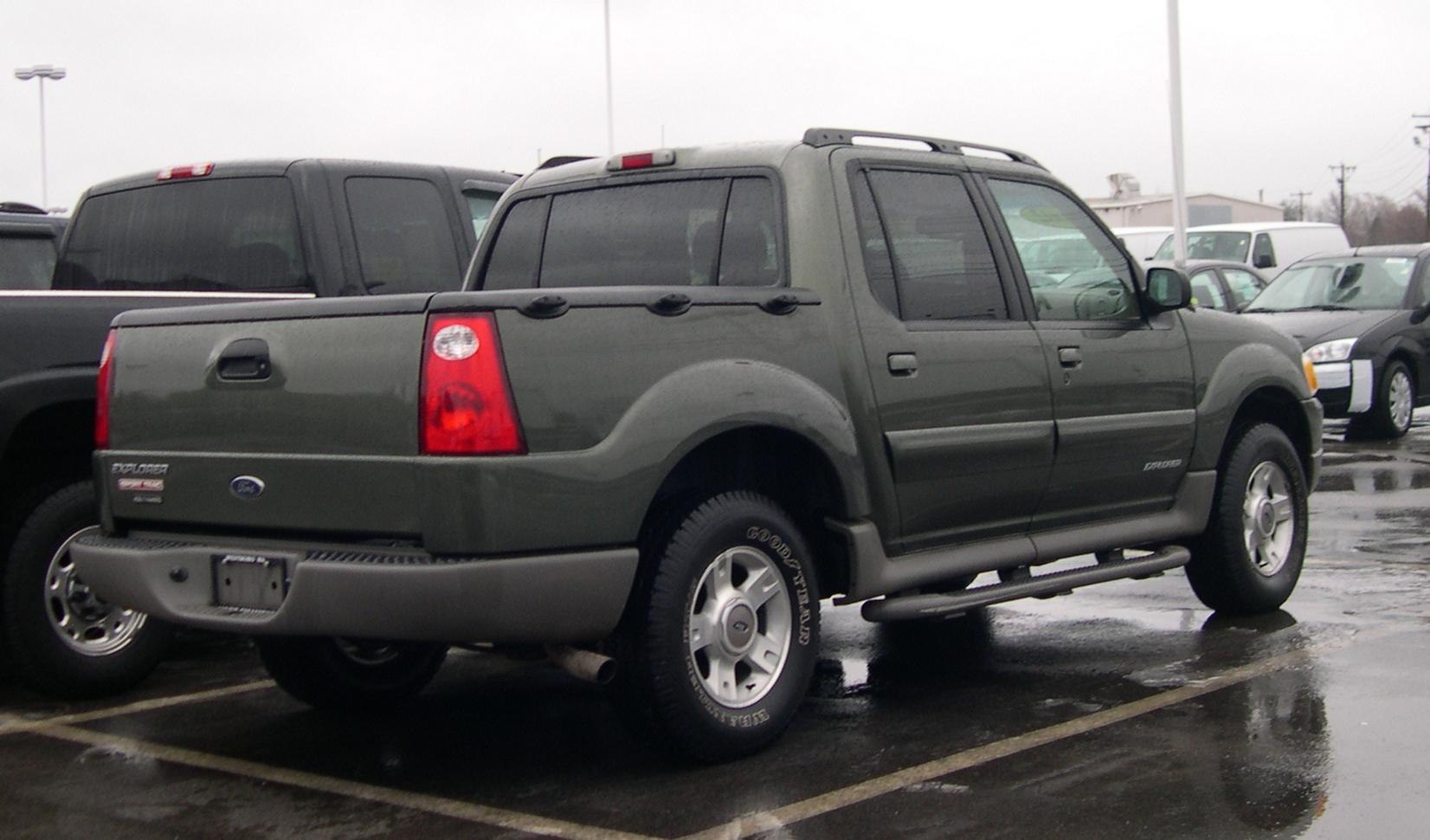 Rear side view of a double cab pickup with roof rails and side steps