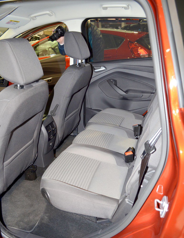 Rear passenger seats and interior door panel with fabric upholstery and ergonomic design