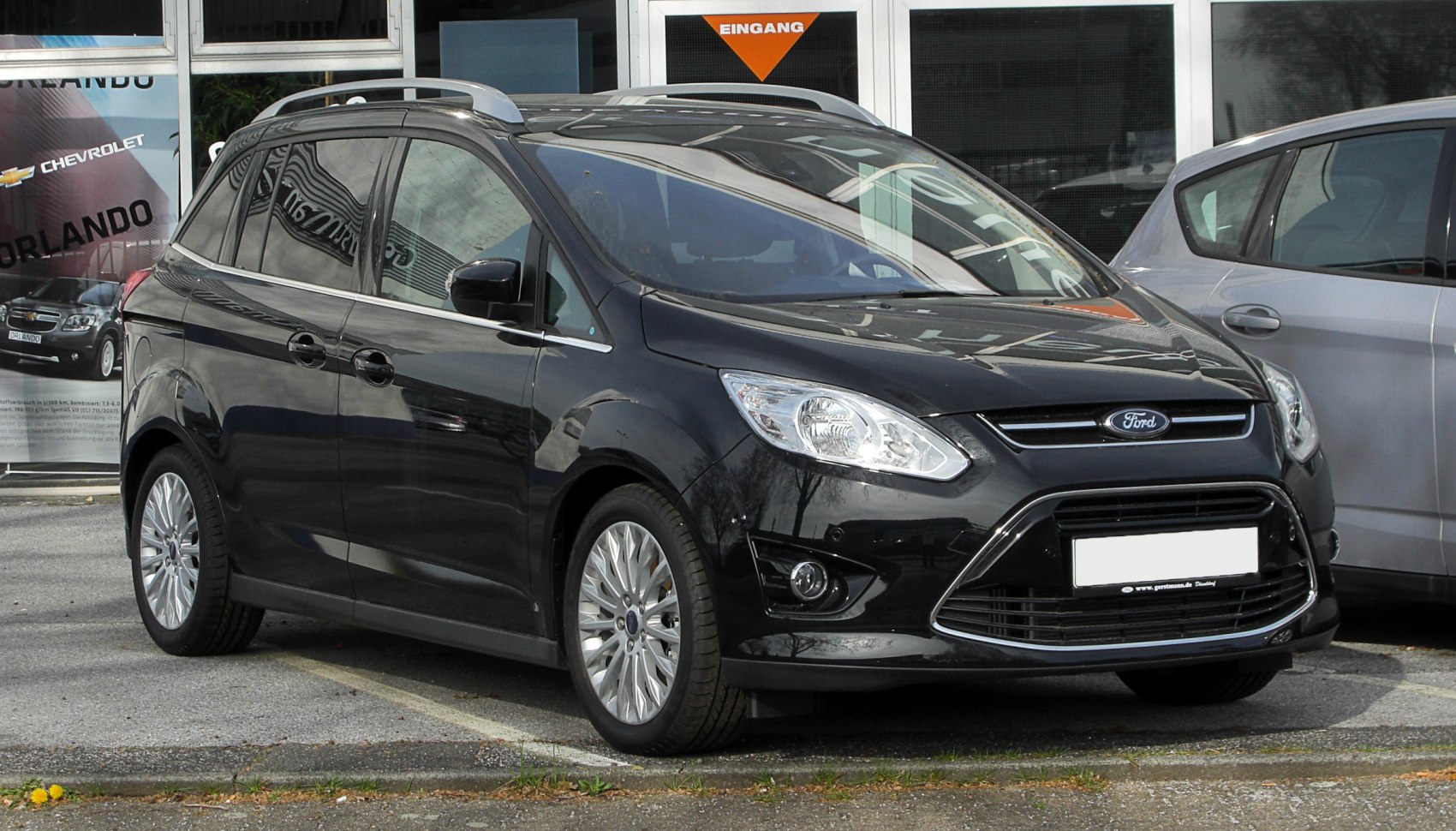 Front side view with prominent headlights and roof rails