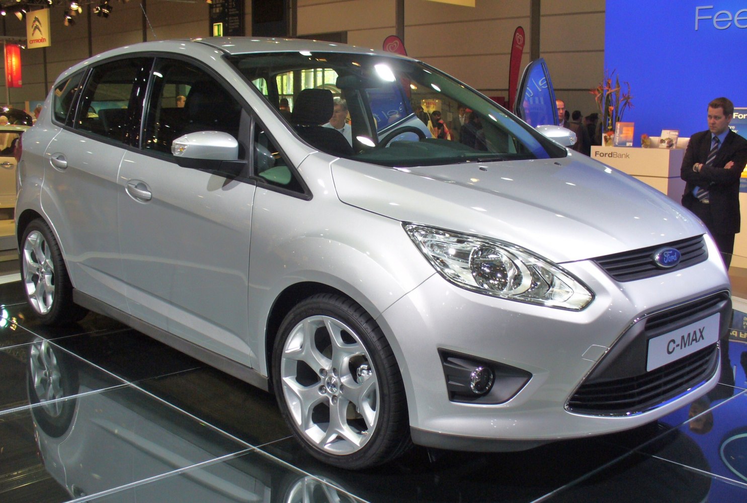 Silver hatchback with prominent headlights and alloy wheels