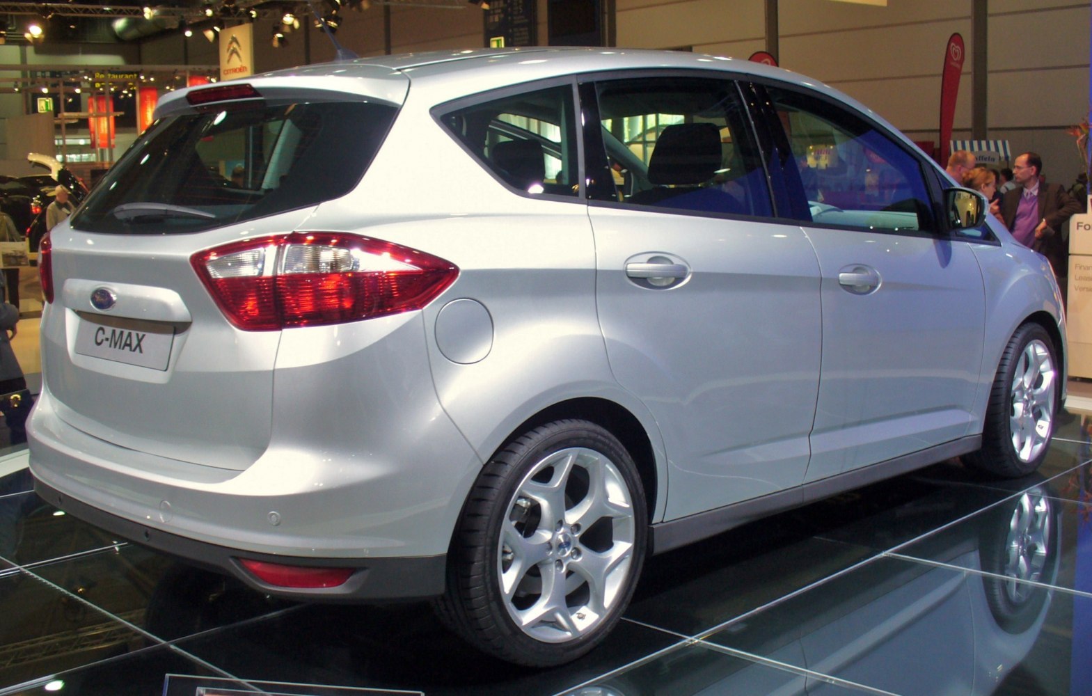 Silver compact multi-purpose vehicle rear side with taillights and alloy wheels