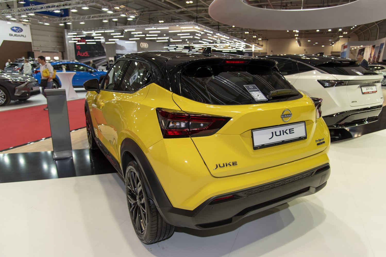 Rear view of yellow and black compact SUV with modern taillights and two-tone design.