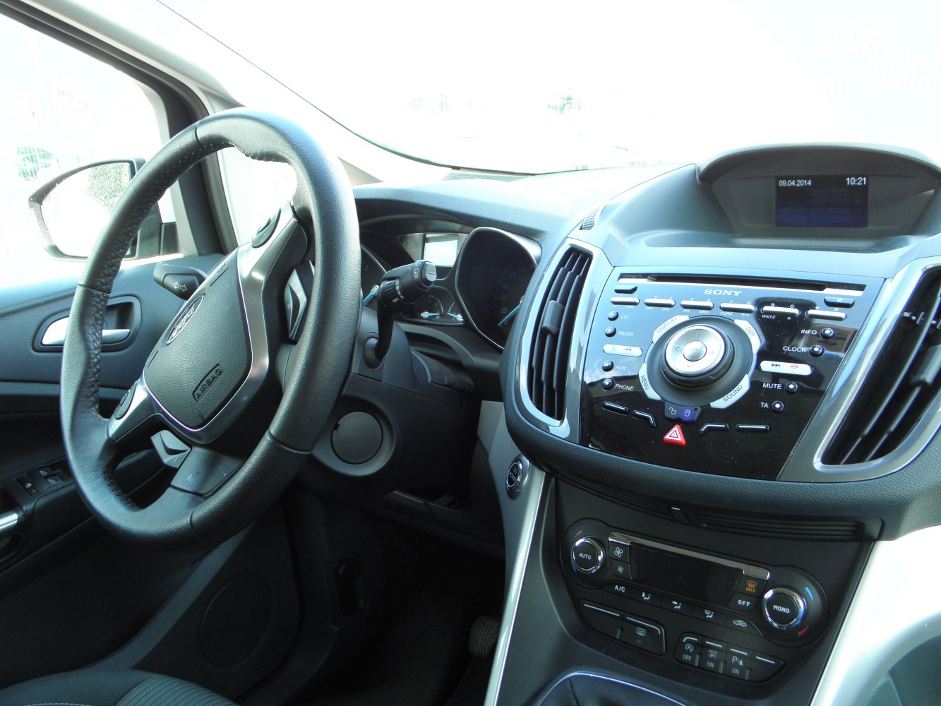Car interior dashboard with steering wheel and control panel