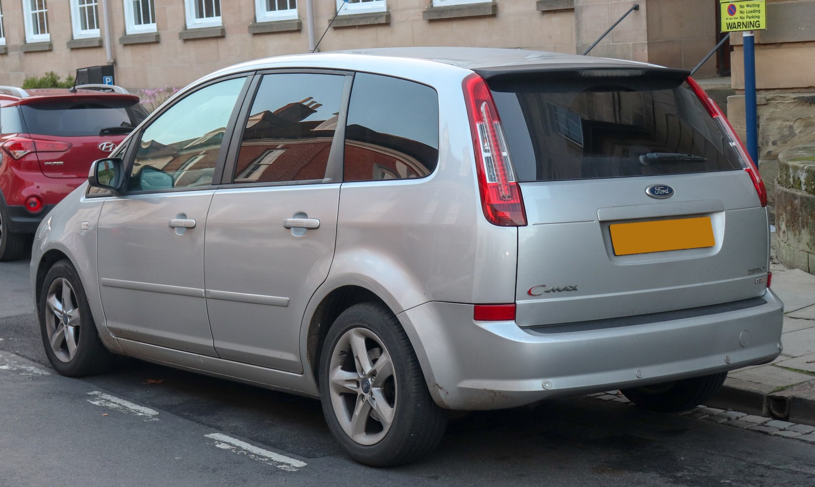 Silver MPV with vertical tail lights and tinted rear windows
